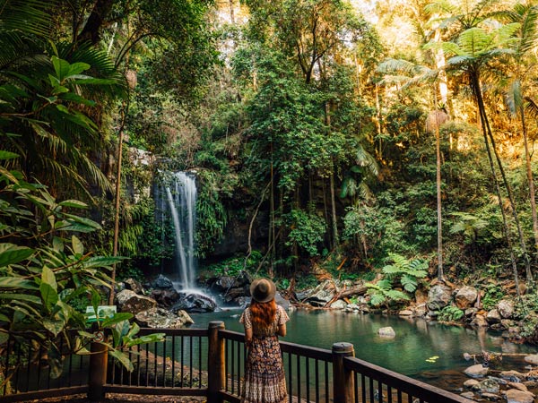 Woman standing in front of Curtis Falls