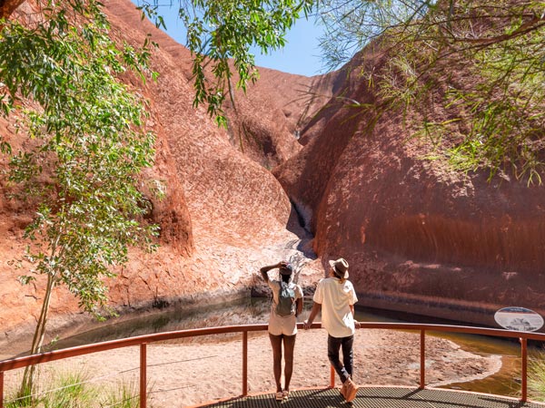 two tourists capturing the Mutitjulu Waterhole