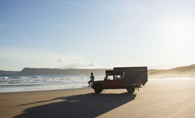 a person sitting on a 4WD vehicle on Cloudy Bay