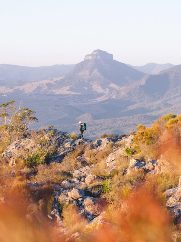 Man standing at the top of Mount Maroon after doing hike