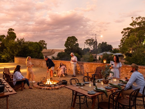 a group of people hanging out around a bonfire at Kingsford Homestead Barossa