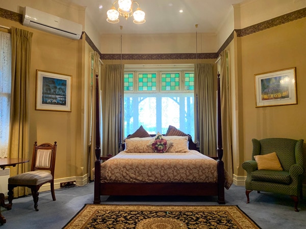 a traditional but cosy bedroom inside Langley Estate