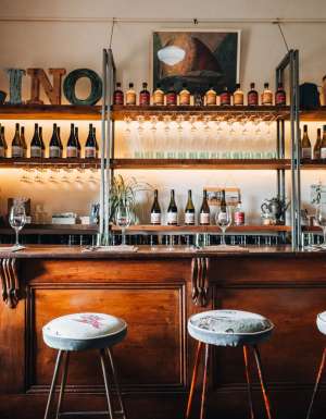 empty chairs and wine bottles displayed inside the Lino Ramble winery, McLaren Vale