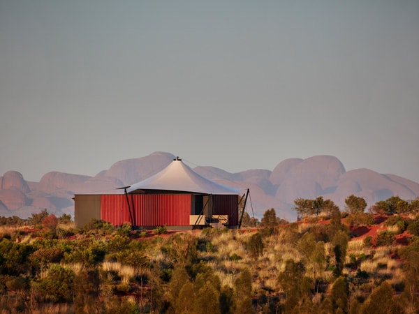 a glamping tent in the middle of the rugged landscape at Longitude 131, Uluru