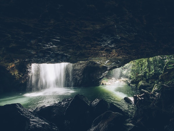 Waterfall coming from natural bridge above in Springbrook National Park