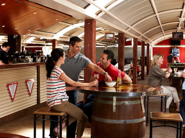 Couple sitting at barrel at Outback Pioneer Hotel and Lodge in Uluru