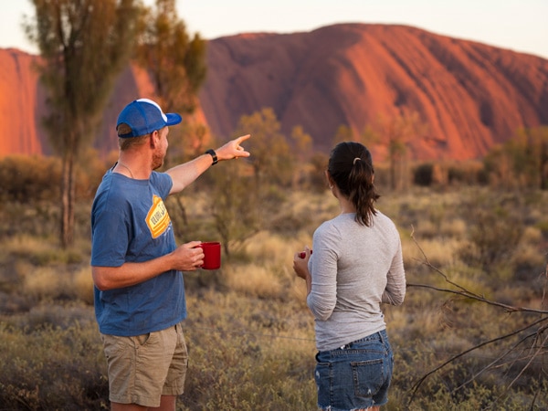 a couple gazing out the Uluru landscape