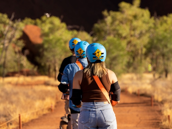 a group of travellers wearing a helmet during an Uluru Segway Tour