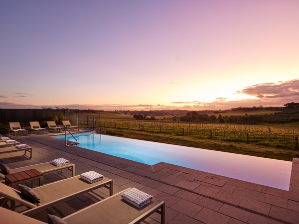 an outdoor pool amidst a sunset backdrop