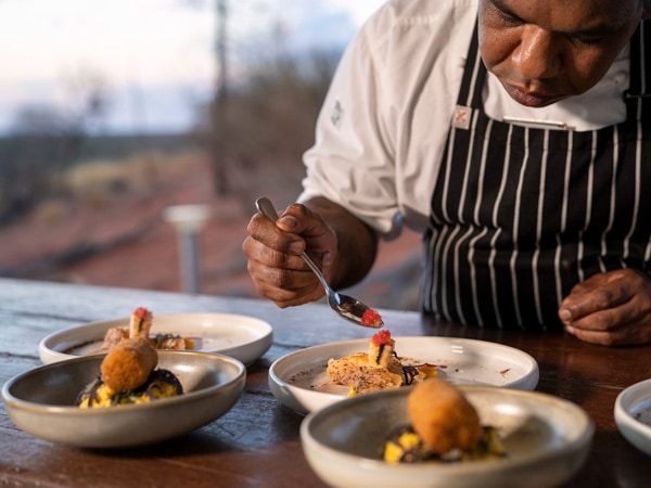a chef carefully prepares the dishes for Tali Wiru dining