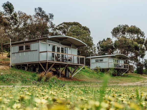 two villas nestled on an elevated part of the surrounding lush landscape