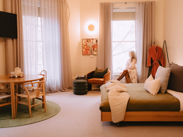 a woman relaxing in her suite at Bendigo Ernest Hotel