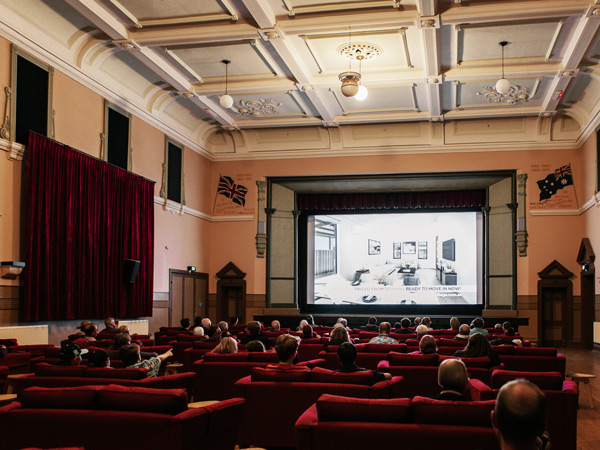 filmgoers watching a movie inside Star Cinema