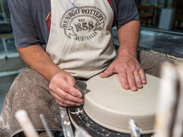 an artisan creating pottery at Bendigo Pottery