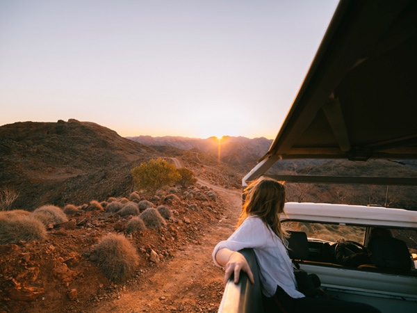 a girl in the car driving along the outback South Australia
