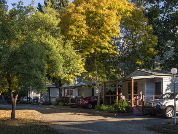an outdoor parking area surrounded by lush canopy at Discovery Parks Bright