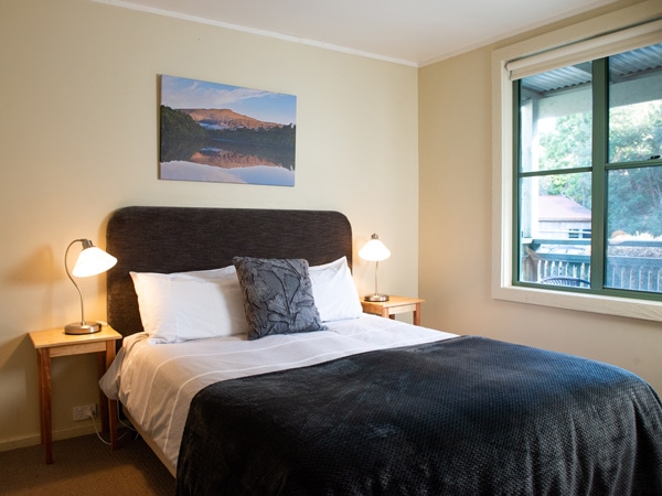 a bedroom suite inside the rustic cottage in Corinna