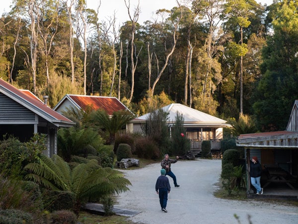 people standing on the road with houses on the side