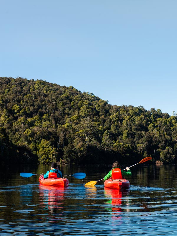 visitors kayaking through the waters of the Corinna wilderness