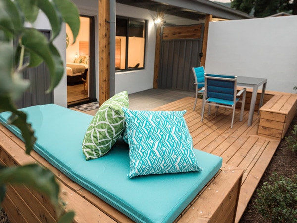 an outdoor deck with a comfortable seating area at Bright Colonial Motel