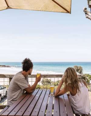 Couple having a schooner each at the Wye Beach Hotel on the Great Ocean Road