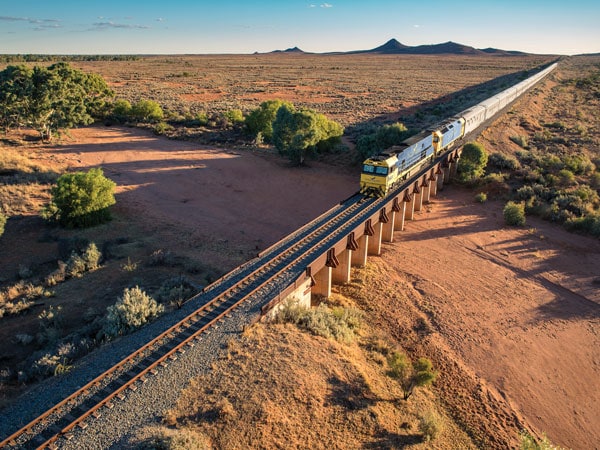 the Indian Pacific train passing through the elevated tracks above Broken Hill