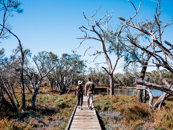 Couple walking by Lake Goegrup, Mandurah