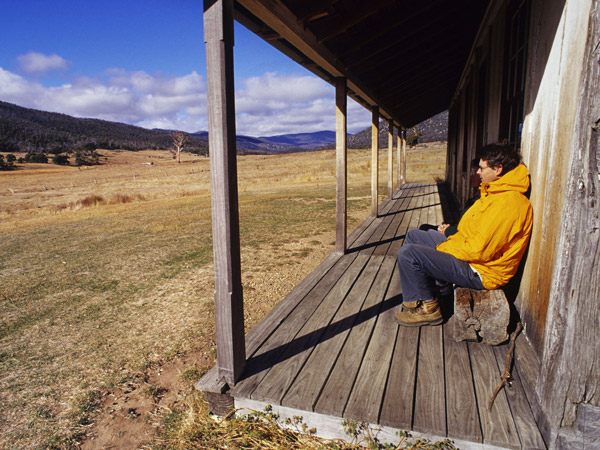 a man sitting outside a homestead, Orroral