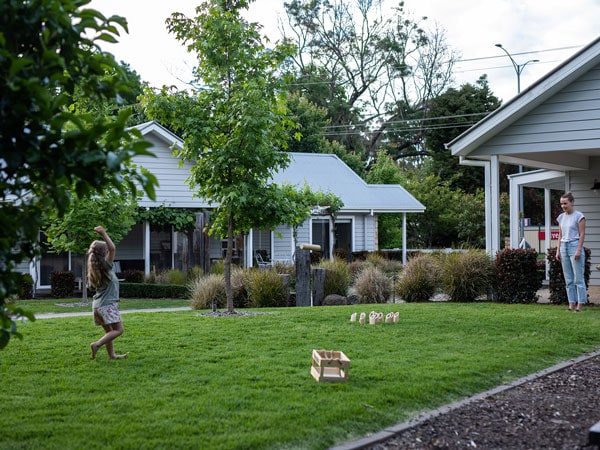 a mother and daughter playing at an expansive garden in Our Place Bright