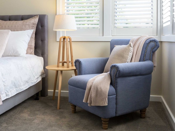 a sofa beside a lamp and bed at Our Place Bright