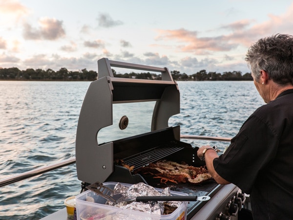 Chef cooks food on a Wild Seafood Experience on Mandurah Cruises