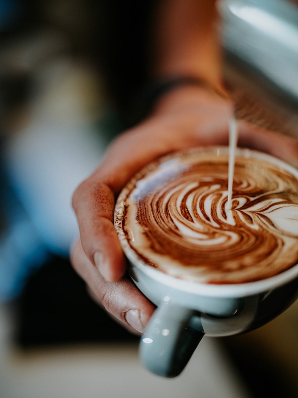 a hand holding a cup of coffee