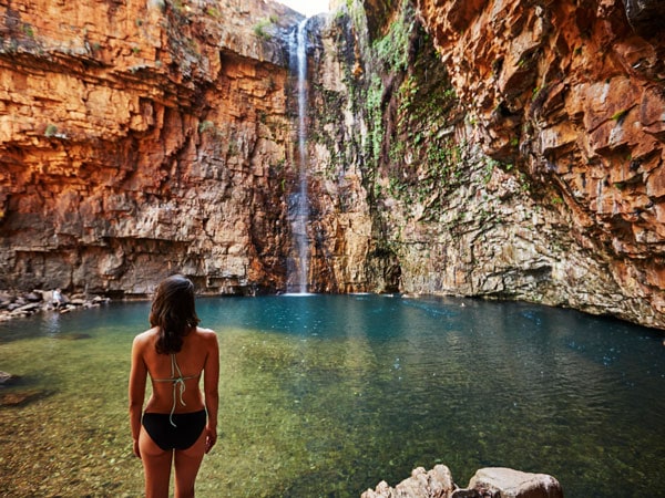 a woman standing in front of Emma Gorge's waterfall