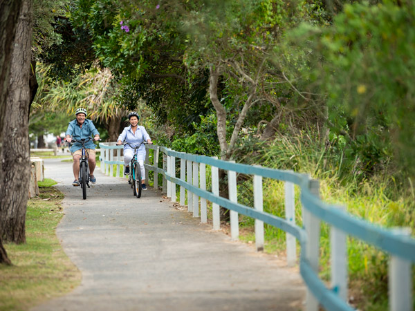 a couple biking in Yamba