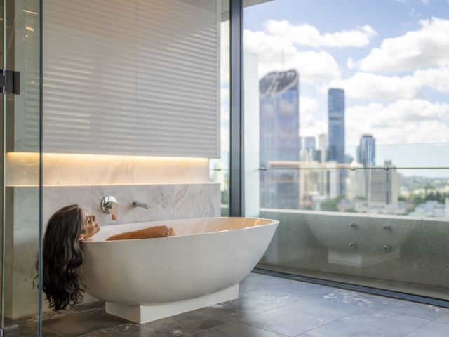 a woman relaxing in a tub at Emporium Hotel South Bank, Brisbane