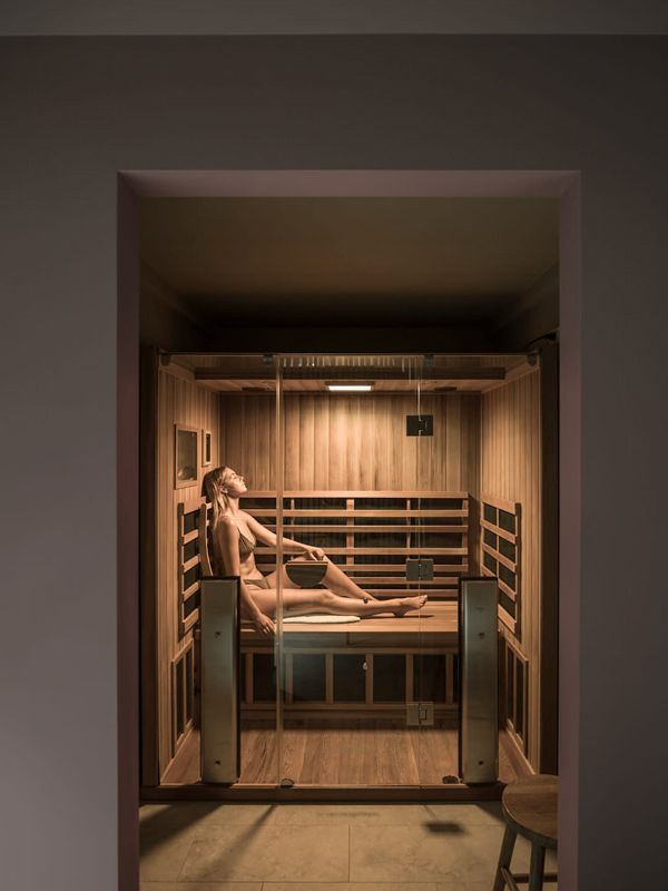 a woman relaxing in a traditional cedar sauna at Native State, Gold Coast spas