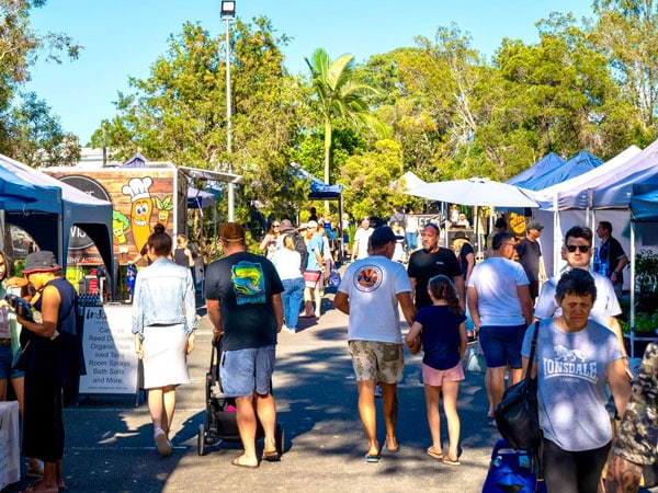 people strolling around the stalls at Helensvale Farmers Market, Gold Coast