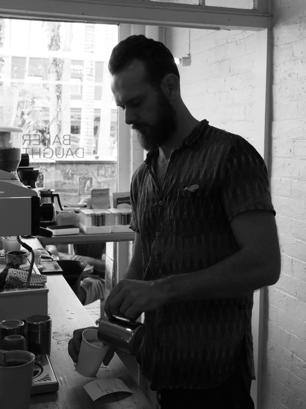 a barista making coffee at Baker & Daughters, Byron Bay