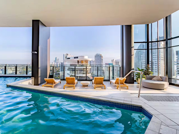 an indoor pool with sunloungers at Lilet Airbnb, Broadbeach accommodation