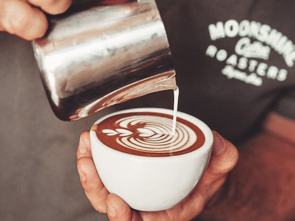 pouring milk over coffee at Byron Moonshine Coffee Roasters