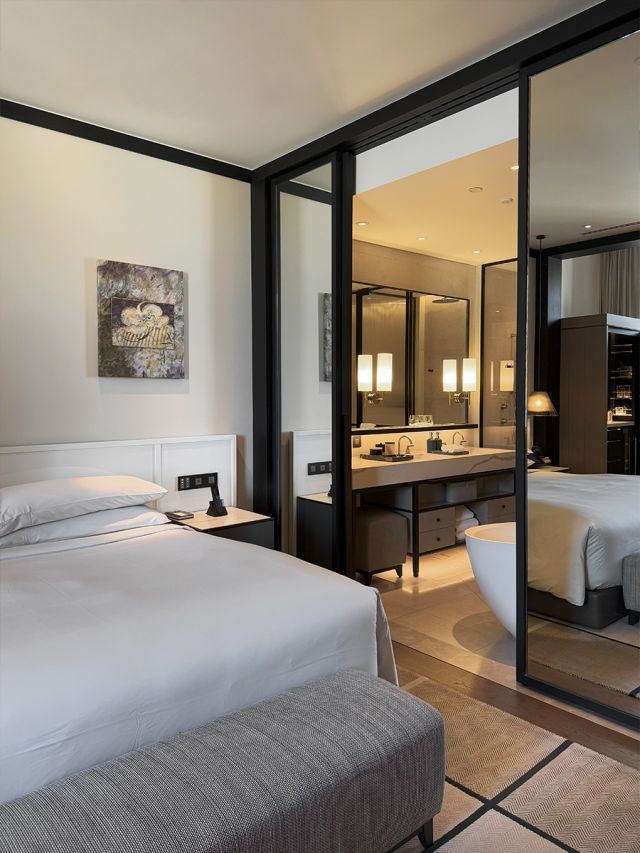 A modern hotel room with a monochrome paletter.
