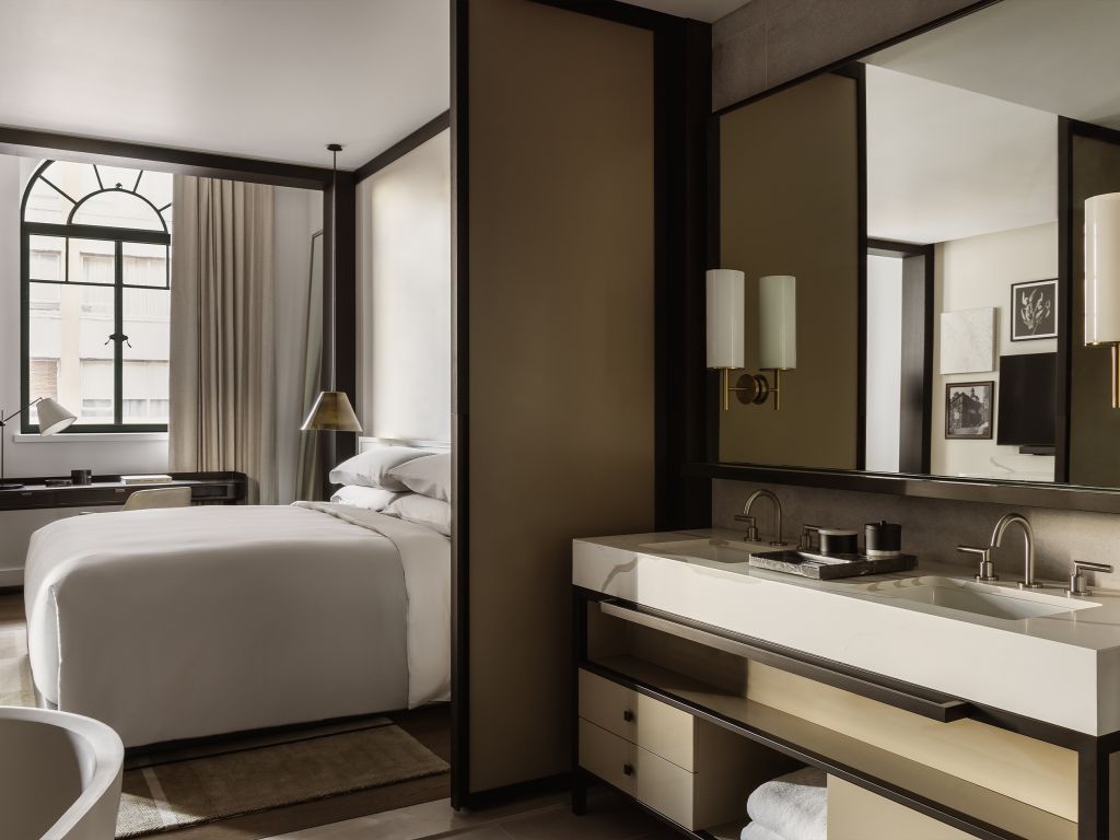 A modern hotel room with a monochrome palette.
