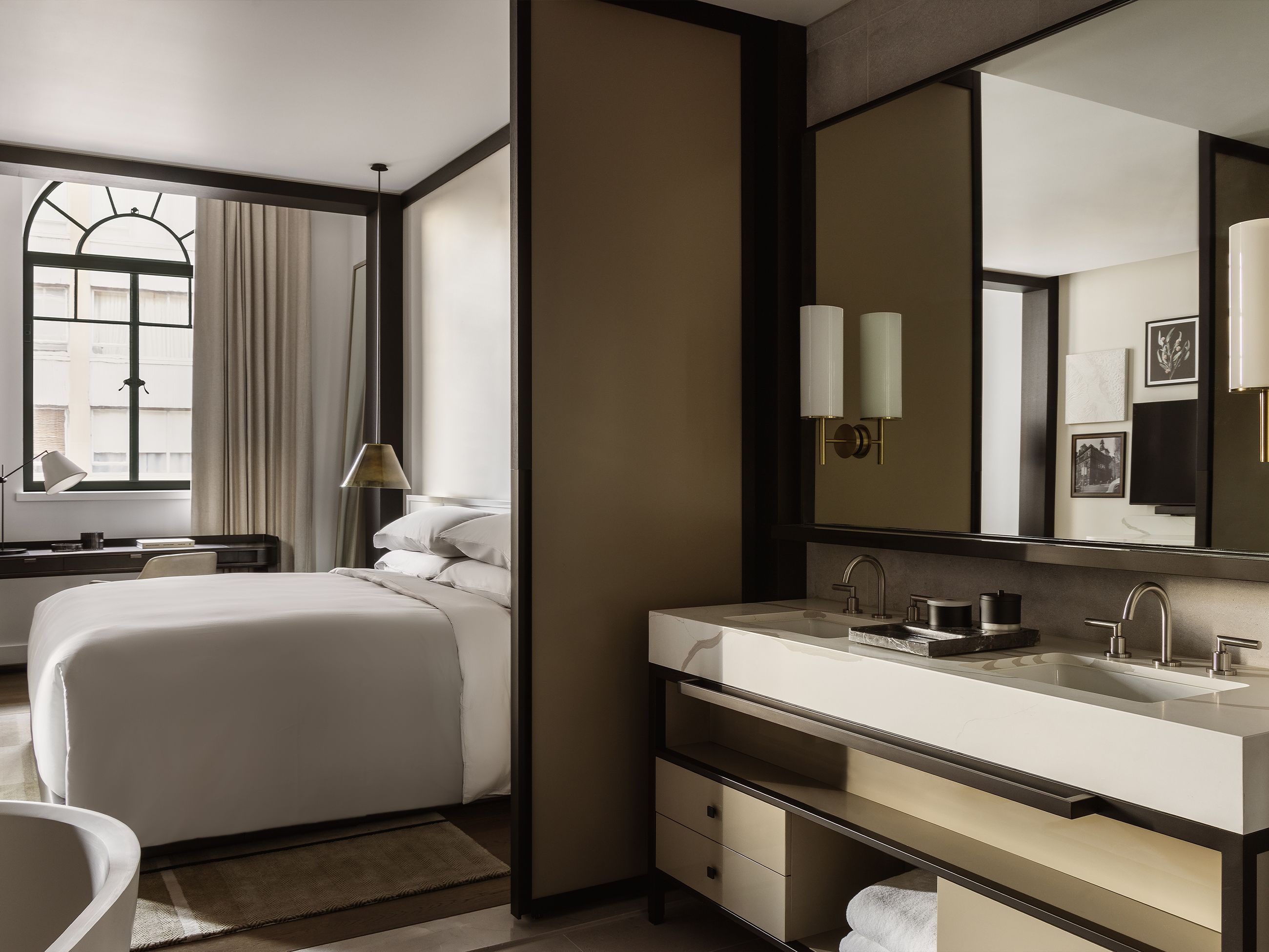 A modern hotel room with a monochrome palette.
