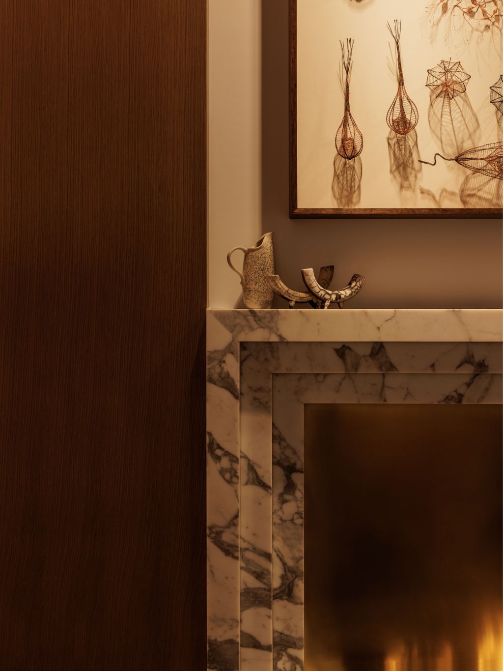 A marble fireplace with objet d'art on the mantle.