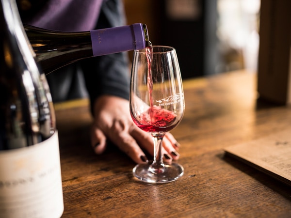 pouring red wine into the glass