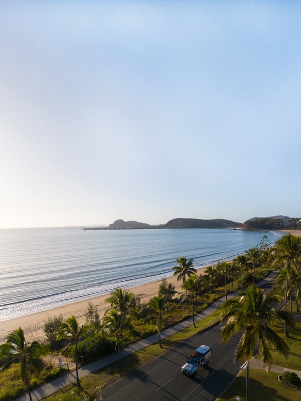 an aerial view of cars driving past Lammermoor Beach