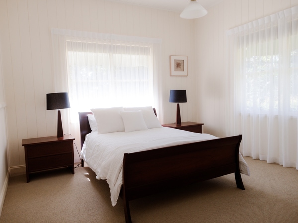 a whitewashed bedroom inside Round Hill Retreat 