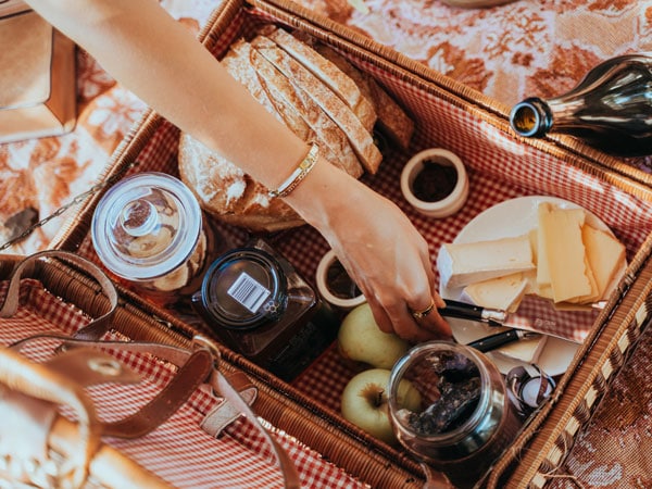 a hand reaching for cheese