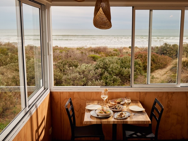 a dining setup overlooking the sea at Kuti Shack