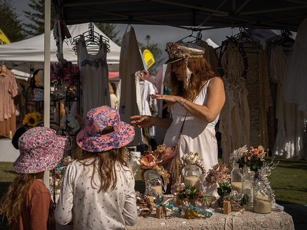 a mom with her kids at a market stall in Byron Bay Community Market